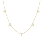 An 18k yellow gold necklace with a series of tri-bezel set diamonds along the chain.