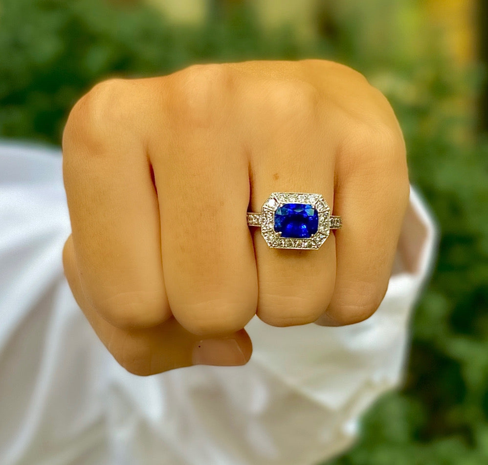 Woman wearing Platinum Sapphire and Diamond Ring designed by Laura Pearce