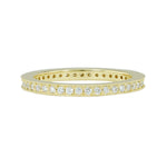 A band ring in 18K yellow gold metal embedded with multiple small diamonds around its entire circumference.