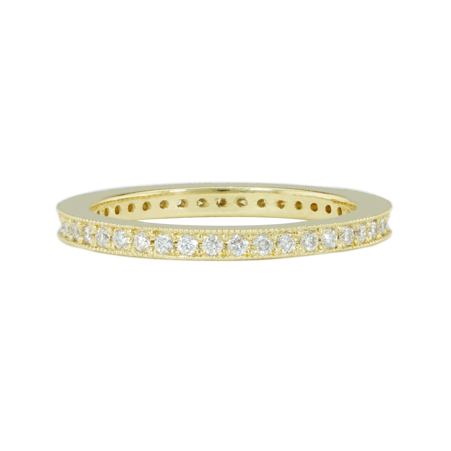 A band ring in 18K yellow gold metal embedded with multiple small diamonds around its entire circumference.