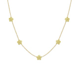 A 18k yellow gold necklace featuring a series of daisy flower stations along the chain.