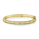 An 18K gold bangle bracelet with diamond accents, featuring mixed shape designs and a clasp closure.