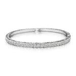 An 18K white gold engraved diamond bangle bracelet 