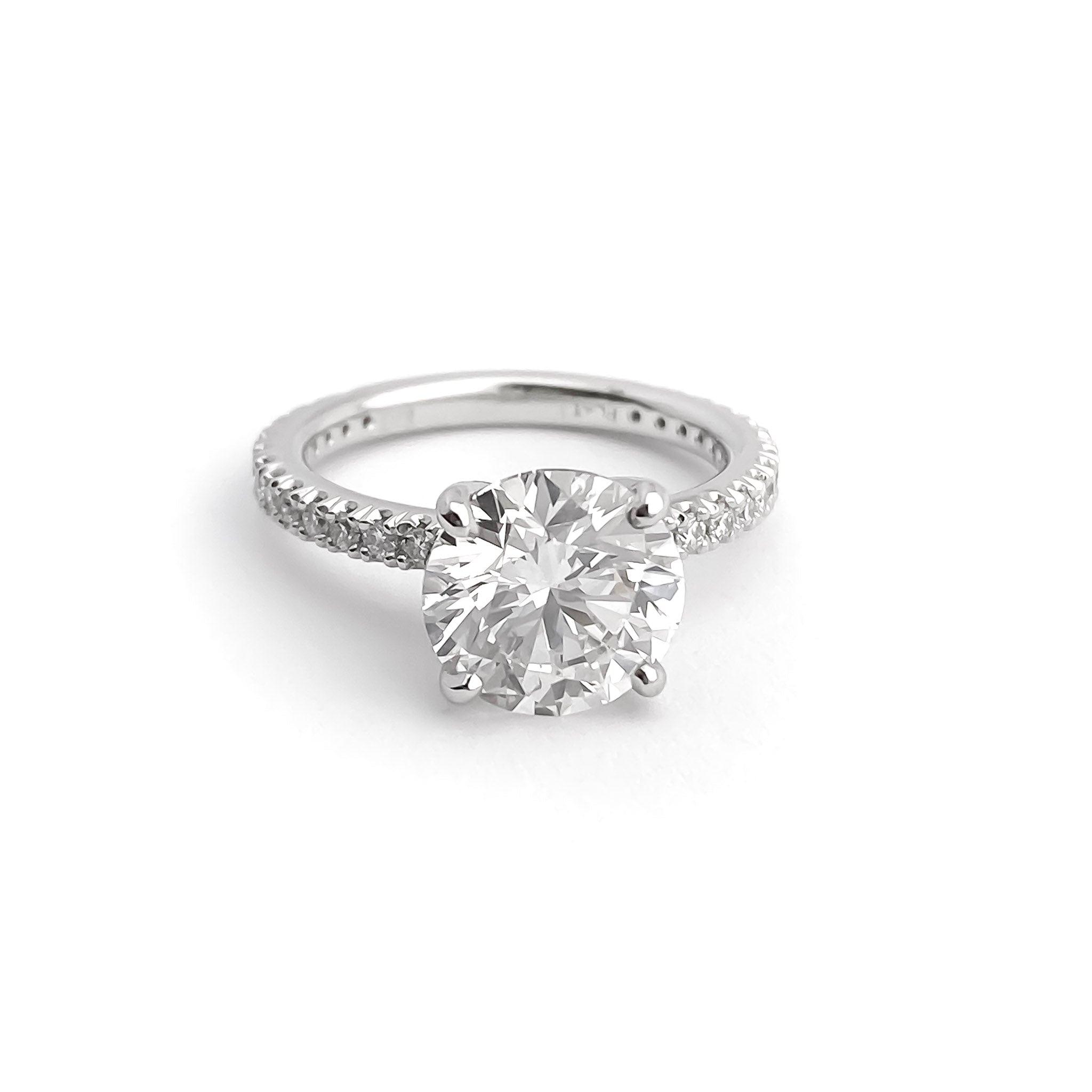 Platinum Round Brilliant Cut Solitaire Diamond Ring with Prong Set Diamond Band