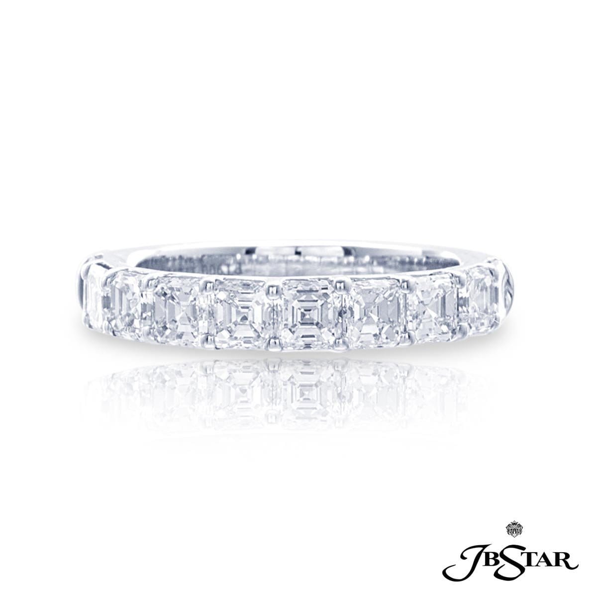A platinum ring with multiple emerald cut diamonds