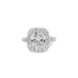 A platinum cushion cut diamond ring with a bead set diamond halo.