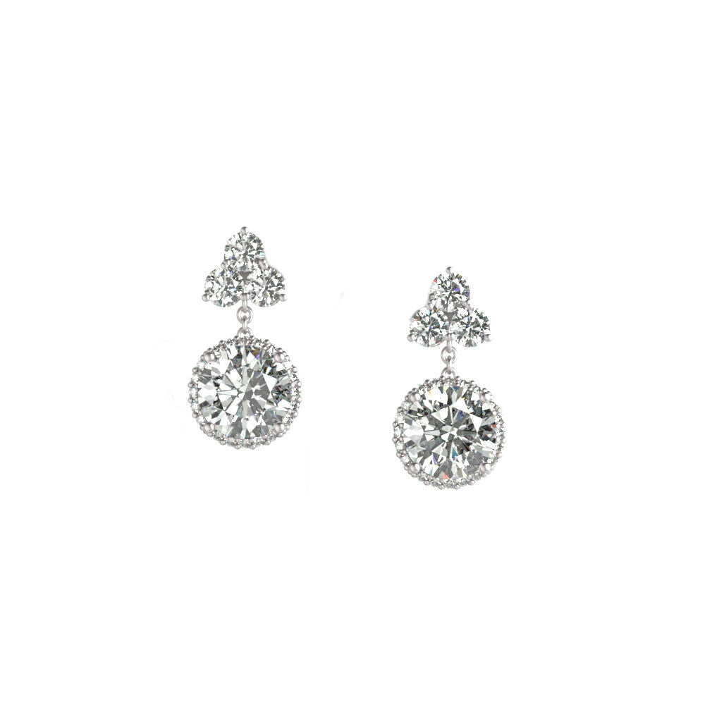 A pair of platinum diamond drop earrings with a round drop diamond