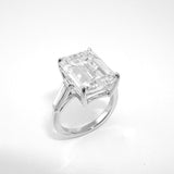 A platinum emerald cut diamond ring with tapered baguette side stones.