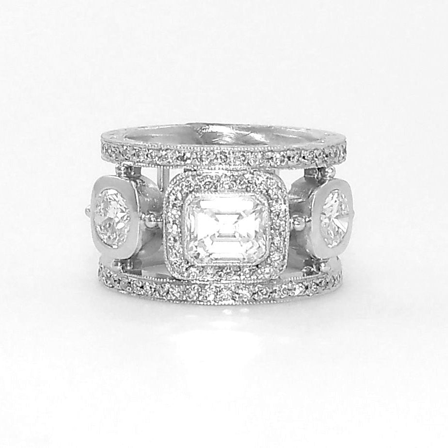 A platinum band ring with emerald cut and round cut diamonds set in it.