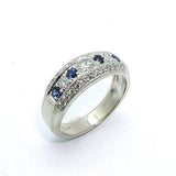 A platinum band ring with blue sapphires and diamonds