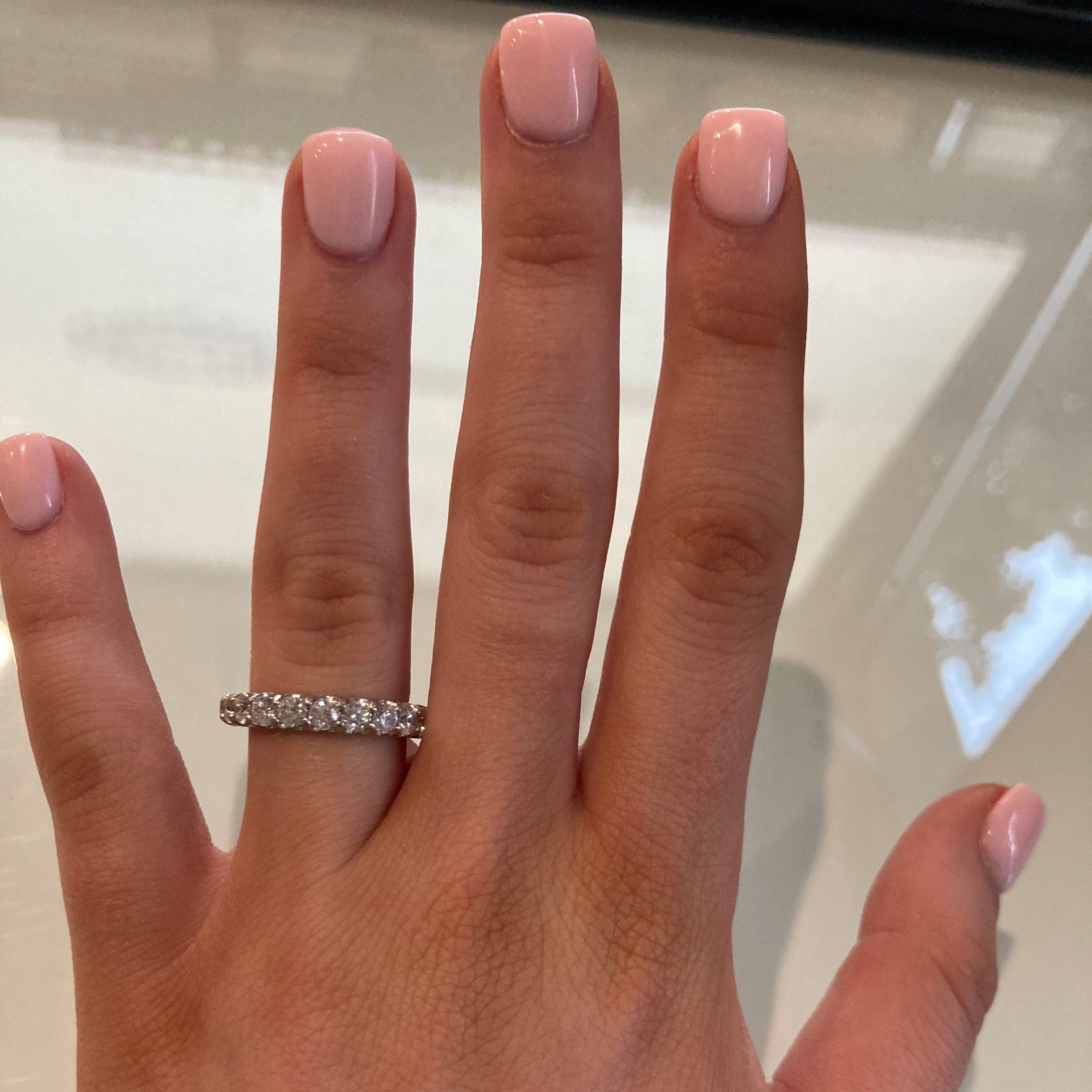 woman wearing platinum shared prong set diamond ring 2.4 carats