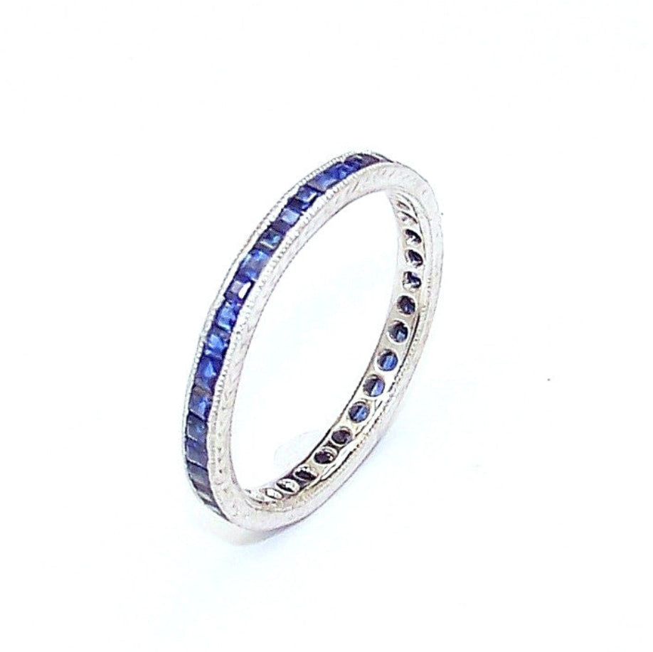 A platinum band ring with square cut sapphires 