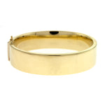 A 14K yellow gold flat polished bangle bracelet with a width of 15.8 mm.