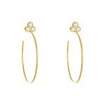 A pair of 18k yellow gold hoop earrings with bezel-set diamonds
