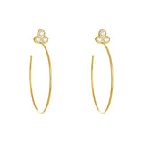 A pair of 18k yellow gold hoop earrings with bezel-set diamonds