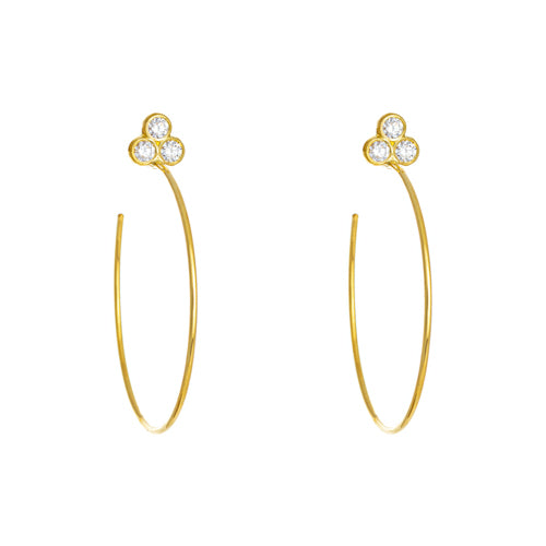 A pair of 18k yellow gold hoop earrings with bezel-set diamonds