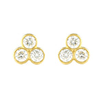 A pair of 18k yellow gold tri bezel diamond stud earrings.