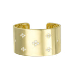 A gold cuff bracelet with multiple diamond accents.