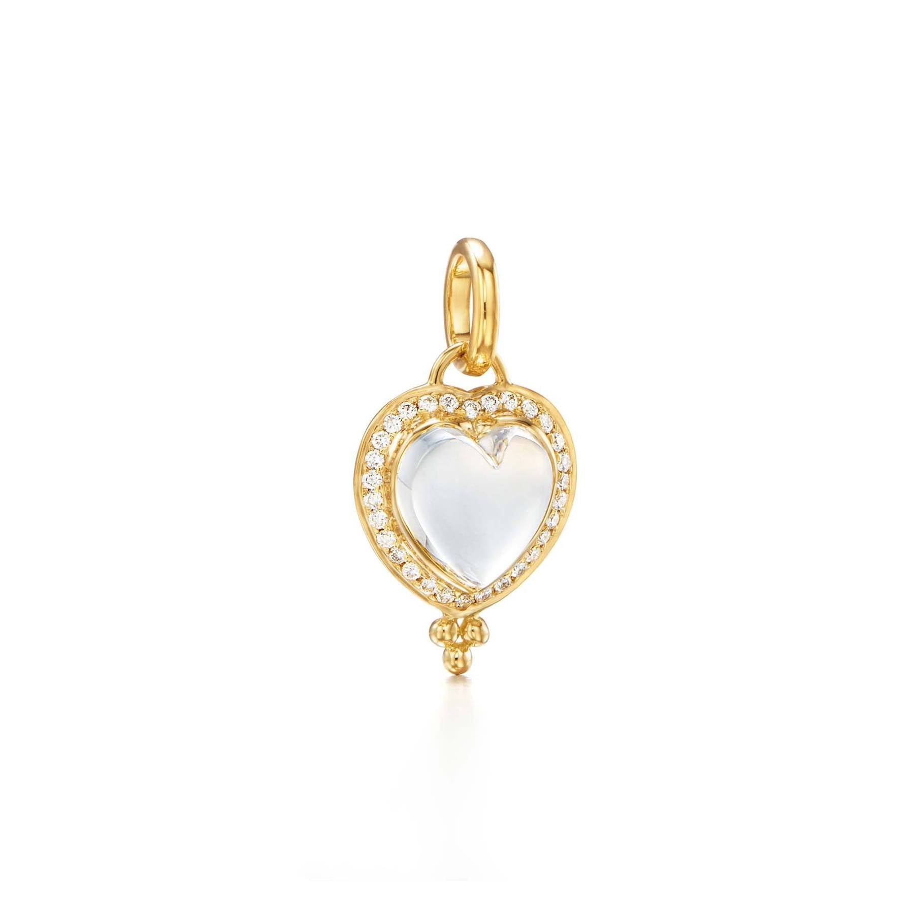 An 18k yellow gold diamond pavé heart pendant with a clear natural rock crystal heart and surrounding diamond accents.
