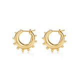 A pair of 18k yellow gold hoop earrings with small protruding gold details designed by Temple St. Clair.
