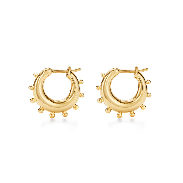 A pair of 18k yellow gold hoop earrings with small protruding gold details designed by Temple St. Clair.