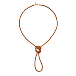 A brown leather cord necklace with a 18K yellow gold clasp designed by Temple St Clair