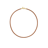 A brown leather cord necklace with a 18K yellow gold clasp designed by Temple St Clair