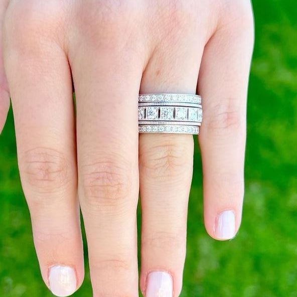 woman wearing multiple platinum diamond band rings
