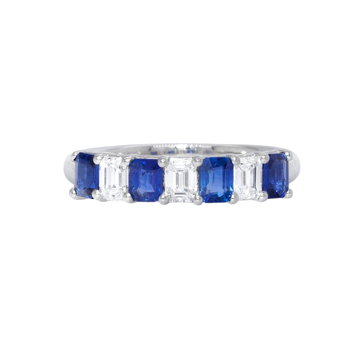 A platinum band ring with alternating blue sapphire and clear diamond stones.
