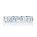 A platinum emerald cut diamond band with nine stones, displayed against a white background.