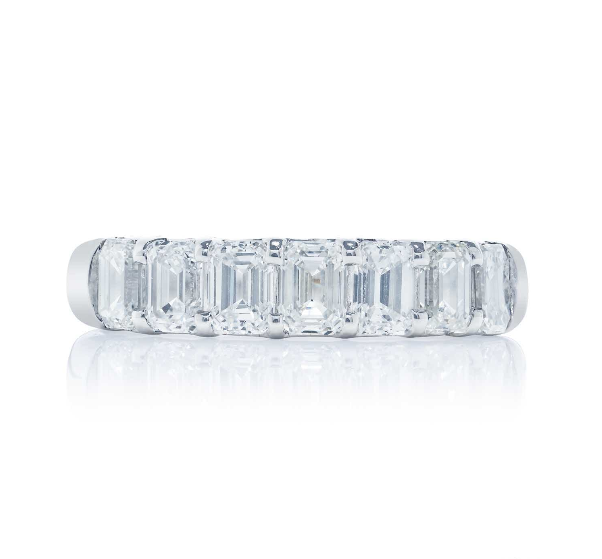 A platinum emerald cut diamond band with nine stones, displayed against a white background.