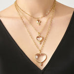 Woman wearing 3 sizes of Temple St Clair Heart Pendants