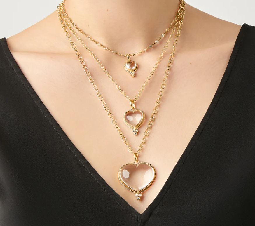 Woman wearing 3 sizes of Temple St Clair Heart Pendants